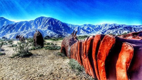 Panoramic shot of mountains against clear blue sky