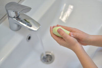 High angle view of woman hand in bathroom