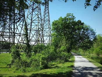 Road amidst trees against sky