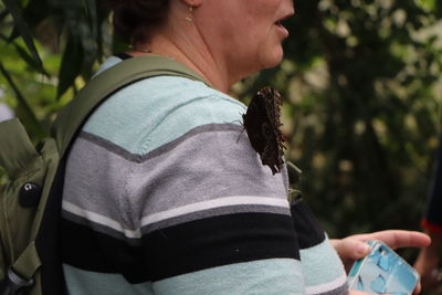 Midsection of woman holding umbrella