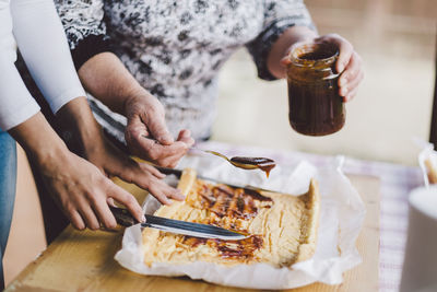 Midsection of man preparing food on table