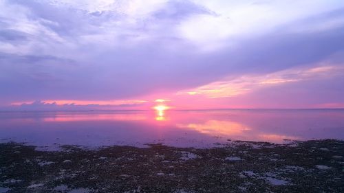 Scenic view of sea against romantic sky at sunset