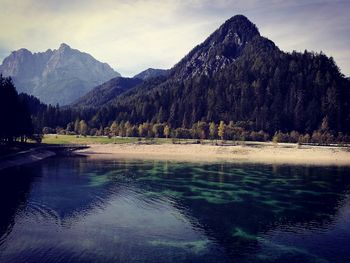 Scenic view of calm lake against mountain range