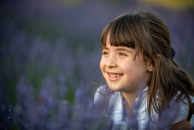 Portrait of happy girl against purple outdoors