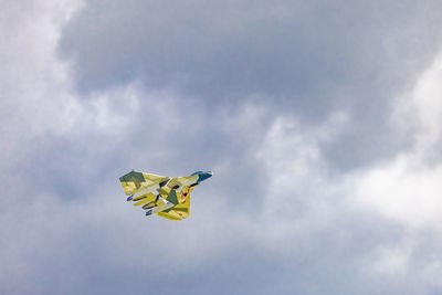 Low angle view of kite flying against sky