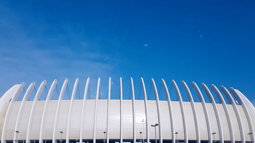 Low angle view of modern building against blue sky