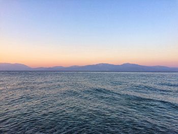 Scenic view of sea against clear sky during sunset