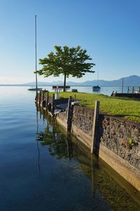 Scenic view of lake against clear blue sky