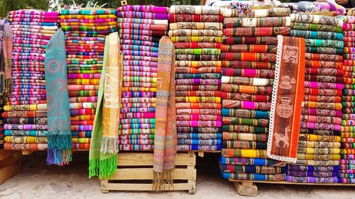 Colorful textiles for sale at market stall