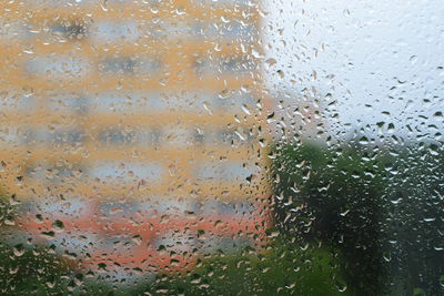 Full frame shot of raindrops on glass window