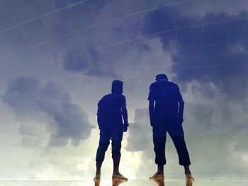 Low angle view of silhouette man walking against sky