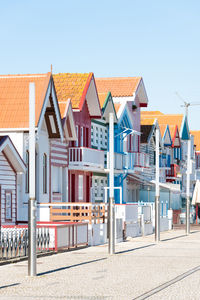 Houses on beach against sky in city