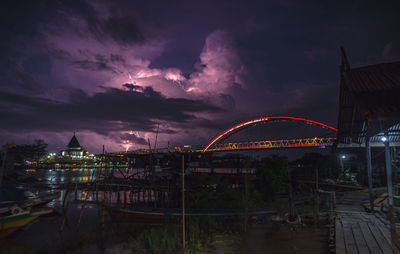Lightning beside bridge and mosque