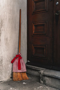 Red broom in front of door