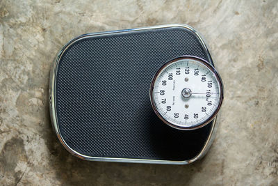 High angle view of clock on table