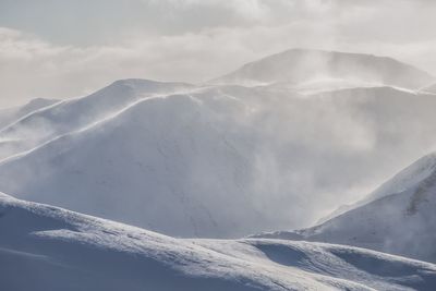 Scenic view of snow covered mountains against sky