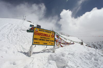 Information sign against sky