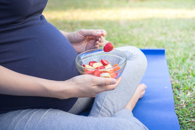 Midsection of woman eating food