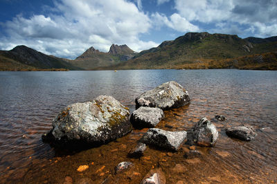 Scenic view of rocks in lake against sky