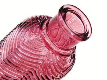 High angle view of pink glass against white background