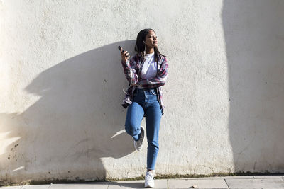 Woman standing against wall