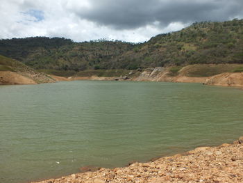 Scenic view of lake and mountains against sky
