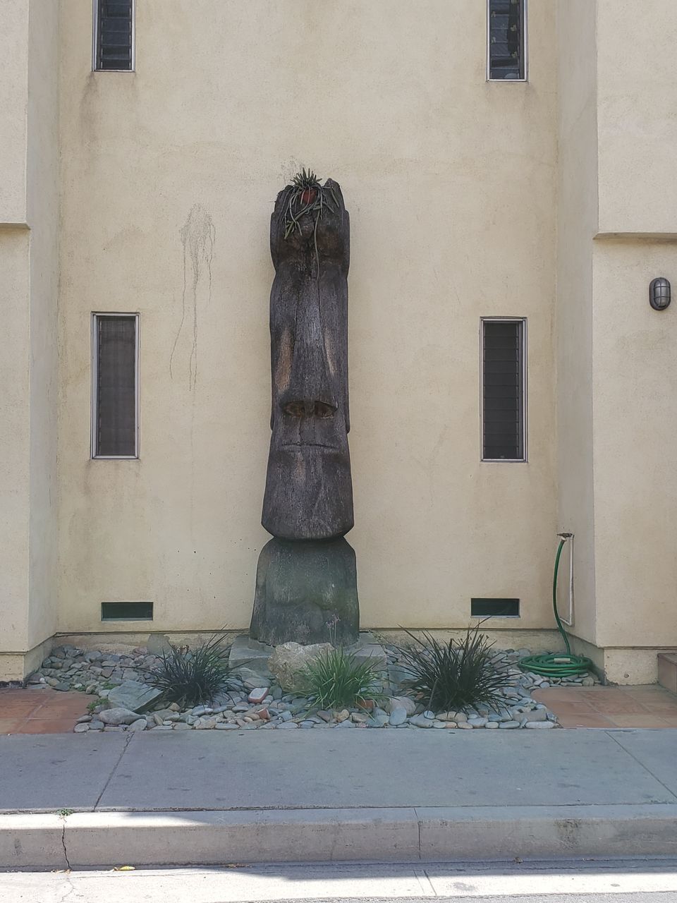 STATUE AGAINST SKY AND BUILDING