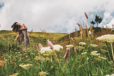 Woman on field against sky
