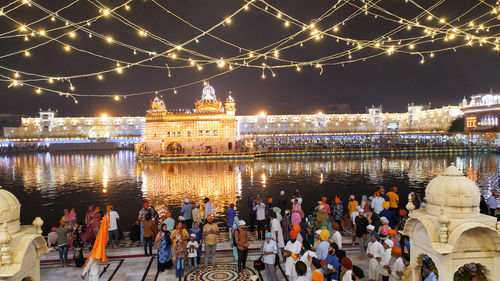 Group of people in illuminated city at night