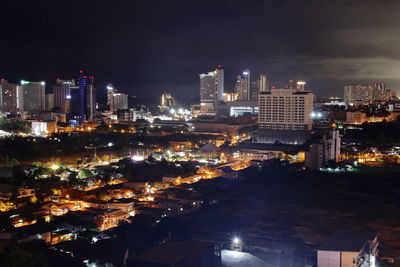 High angle view of illuminated buildings in city at night