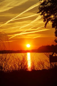 Scenic view of lake against romantic sky at sunset