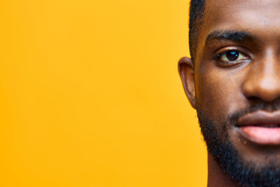 Close-up of man against yellow background