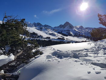 Scenic view of frozen mountains against sky