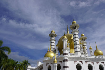 Low angle view of building against cloudy sky