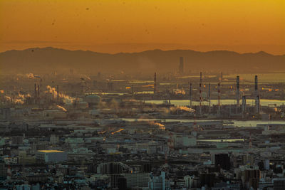 Aerial view of city against orange sky