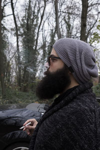 Side view of young man in forest