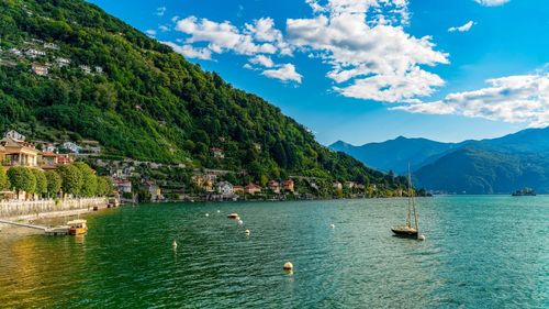 Scenic view of sea and mountains against sky