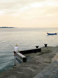 Scenic view of sea against cloudy sky