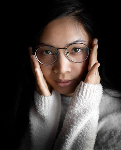 Close-up portrait of a young woman wearing glasses