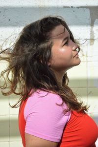 Portrait of young woman looking down while standing outdoors