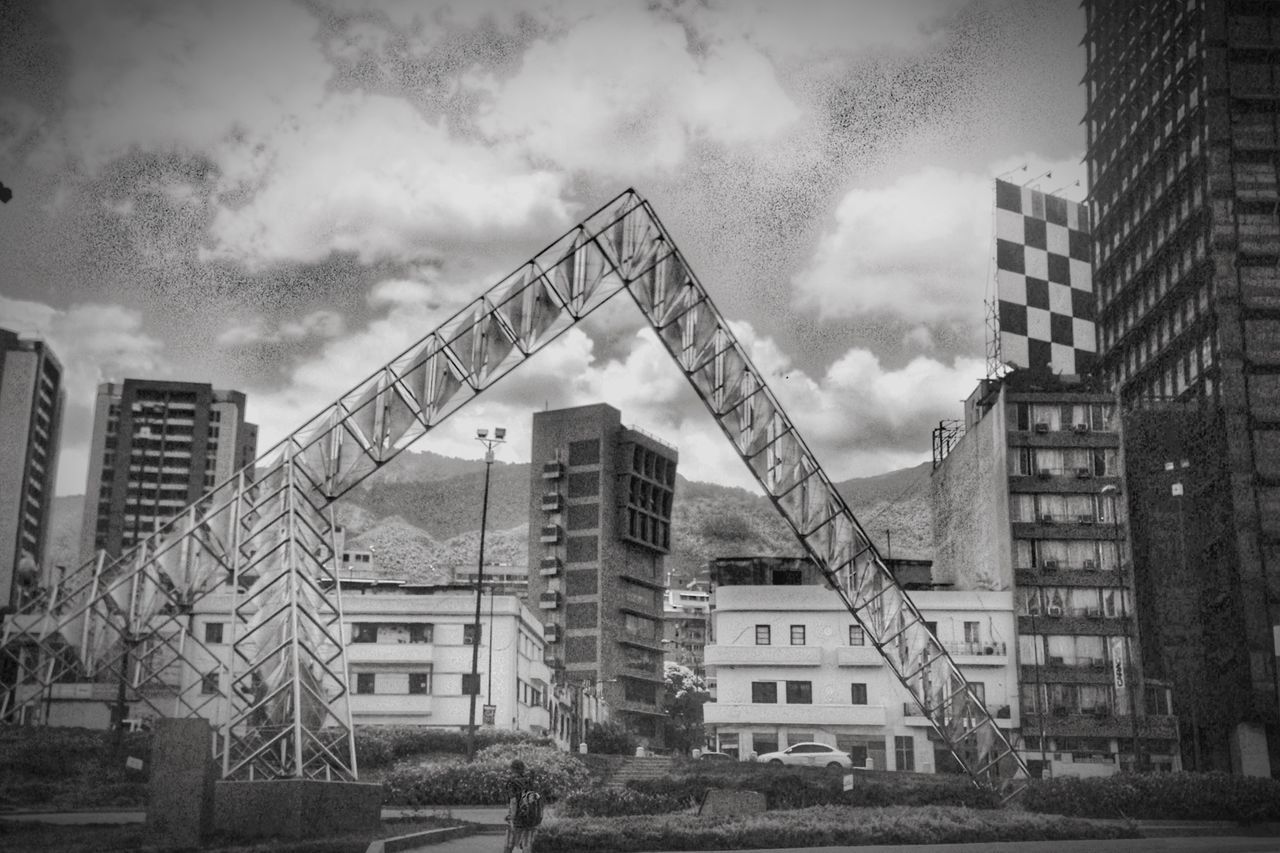 building exterior, architecture, built structure, sky, cloud - sky, cloudy, low angle view, city, building, residential building, residential structure, cloud, outdoors, house, weather, overcast, day, residential district, construction site, no people