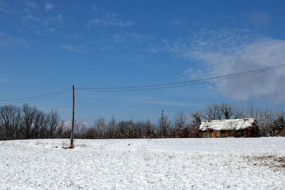 Snow covered field against sky