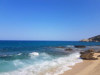 Scenic view of sea against clear blue sky