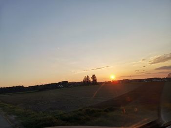 Scenic view of field against sky during sunset