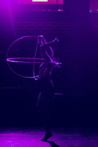 Woman holding illuminated light painting at night