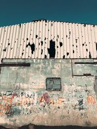 People on wall by sea