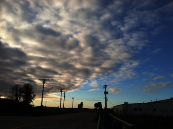 Road against cloudy sky at sunset