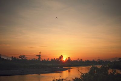 Scenic view of lake against sky during sunset