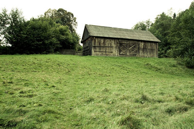 Abandoned house on field against clear sky