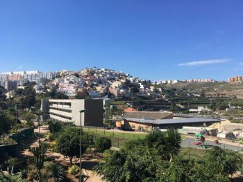 View of townscape against blue sky